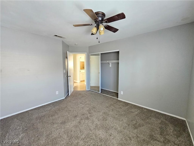 unfurnished bedroom featuring carpet, a closet, visible vents, ceiling fan, and baseboards