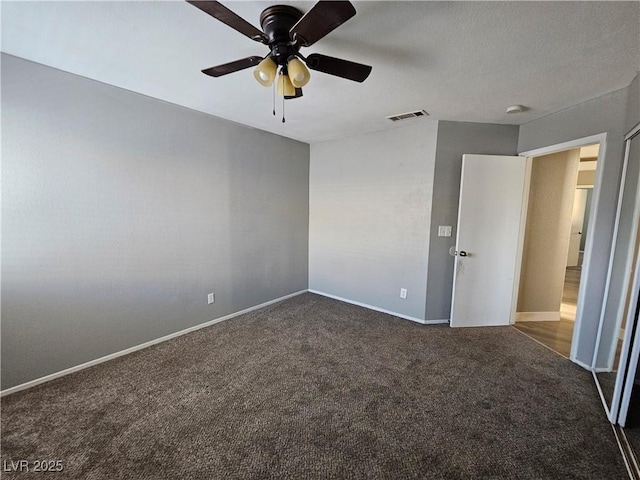 unfurnished bedroom with carpet, visible vents, ceiling fan, and baseboards