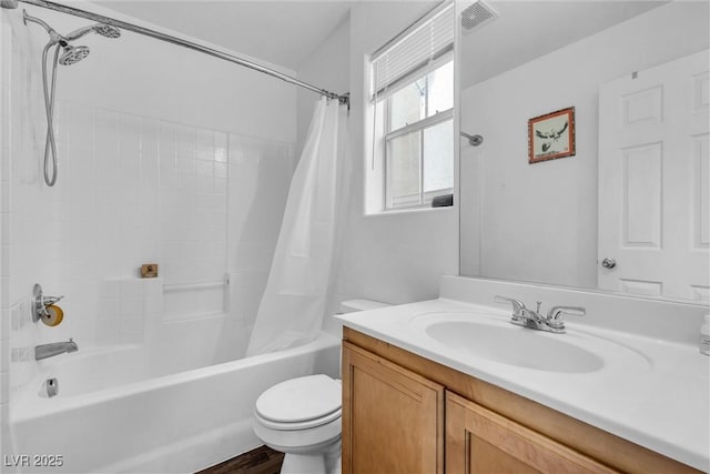 full bathroom featuring visible vents, shower / tub combo with curtain, vanity, and toilet