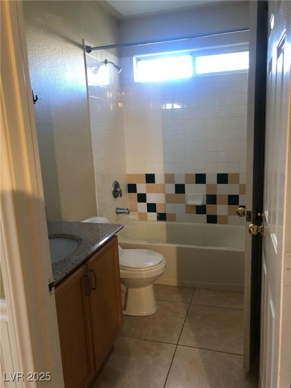 bathroom with tile patterned flooring, vanity, toilet, and shower / tub combination