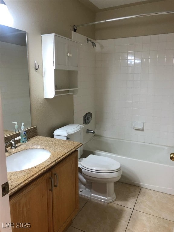 bathroom featuring vanity, tile patterned floors, toilet, and tub / shower combination