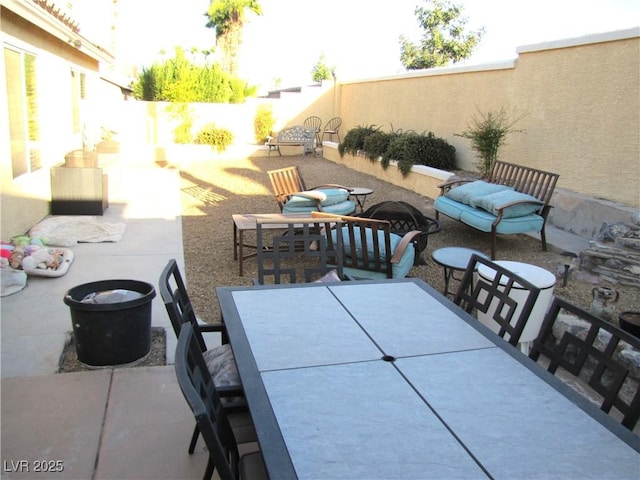 view of patio with outdoor dining area and a fenced backyard