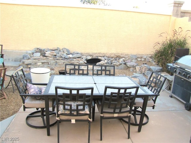 view of patio featuring outdoor dining area and a grill