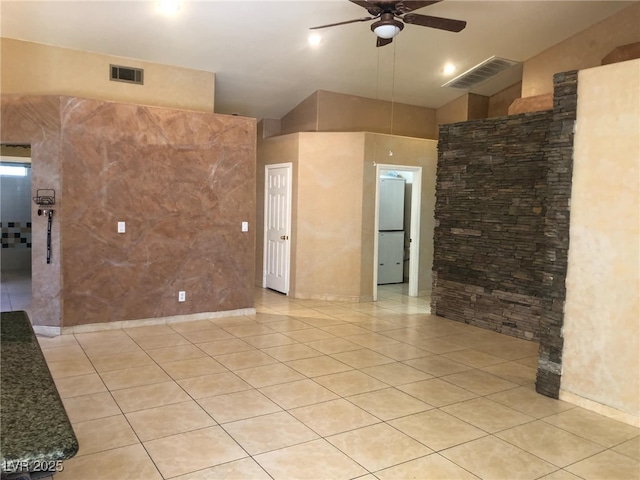 unfurnished room with light tile patterned flooring, visible vents, lofted ceiling, and ceiling fan