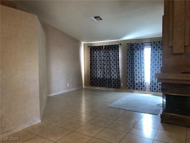 unfurnished room with visible vents, baseboards, and light tile patterned flooring