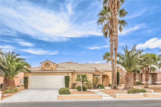 7613 Falconwing Ave, Las Vegas, NV 89131 - mediterranean / spanish-style home featuring driveway, stucco siding, an attached garage, and a tiled roof