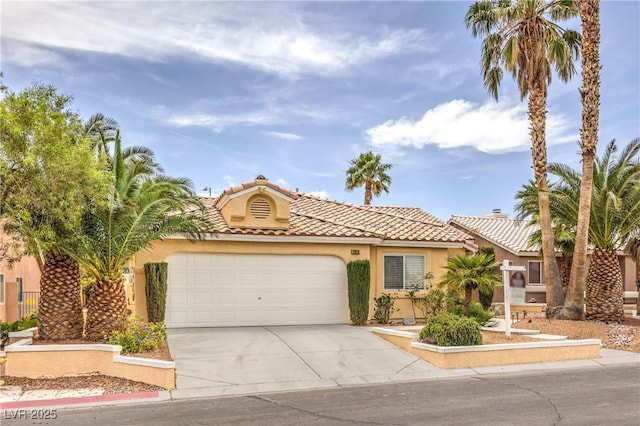 7613 Falconwing Ave, Las Vegas, NV 89131 - mediterranean / spanish home featuring driveway, a garage, stucco siding, and a tiled roof