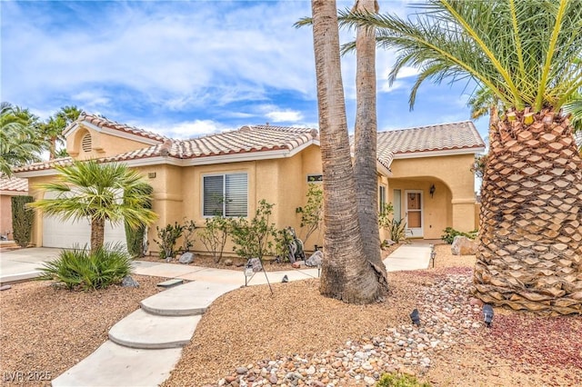 7613 Falconwing Ave, Las Vegas, NV 89131 - mediterranean / spanish-style home featuring concrete driveway, stucco siding, a tile roof, and an attached garage