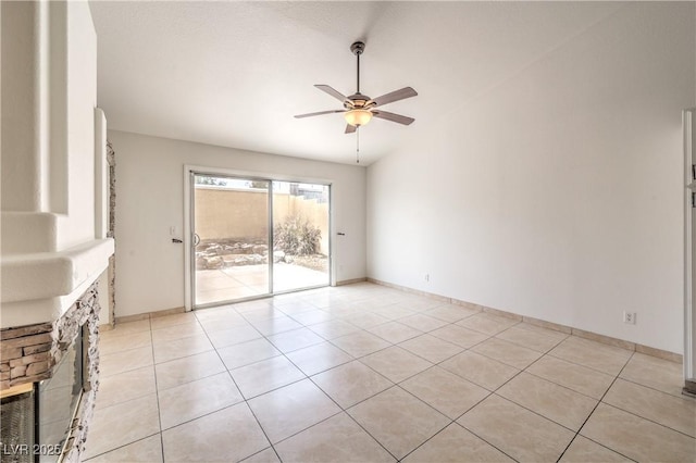 7613 Falconwing Ave, Las Vegas, NV 89131 - unfurnished living room with a ceiling fan, light tile patterned floors, vaulted ceiling, and baseboards