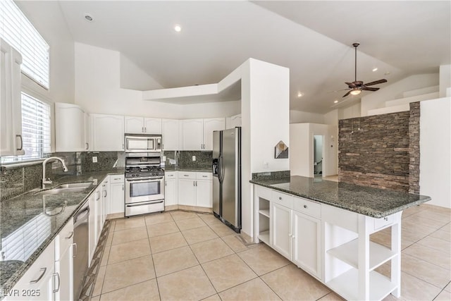 7613 Falconwing Ave, Las Vegas, NV 89131 - kitchen featuring stainless steel appliances, open shelves, a sink, dark stone counters, and high vaulted ceiling