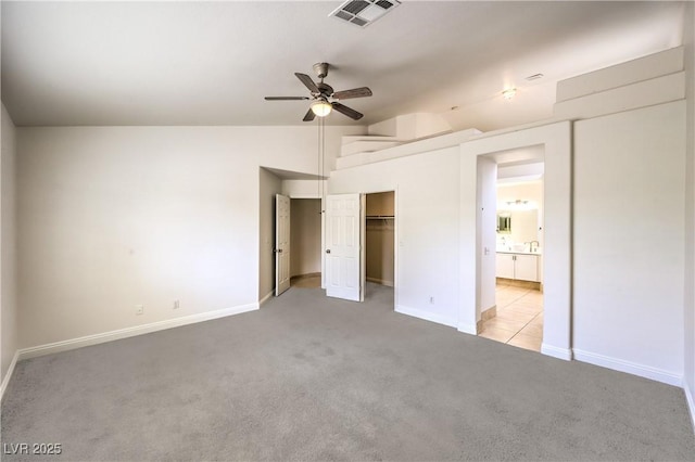 7613 Falconwing Ave, Las Vegas, NV 89131 - unfurnished bedroom featuring light carpet, lofted ceiling, baseboards, ensuite bath, and ceiling fan