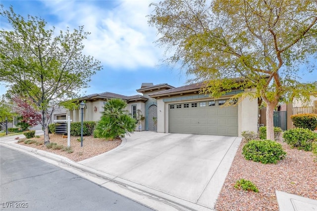 view of front of house with stucco siding, driveway, and an attached garage