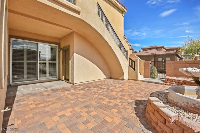 view of patio with a gate and fence