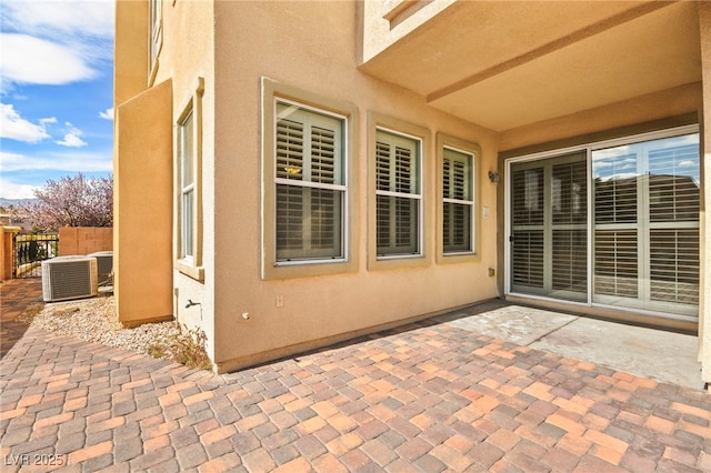 view of patio / terrace with central AC unit and fence