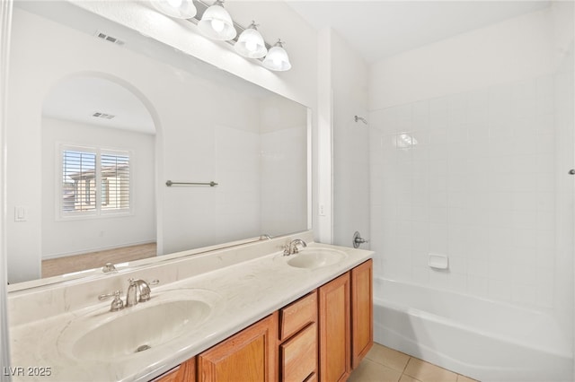 bathroom with tile patterned flooring, visible vents, and a sink