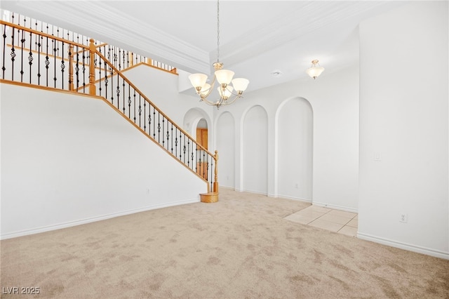 unfurnished living room featuring stairway, carpet floors, arched walkways, crown molding, and a chandelier