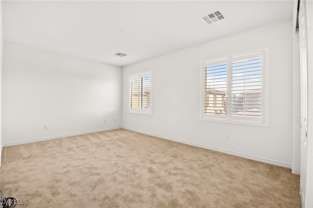 unfurnished room featuring visible vents, baseboards, and carpet floors