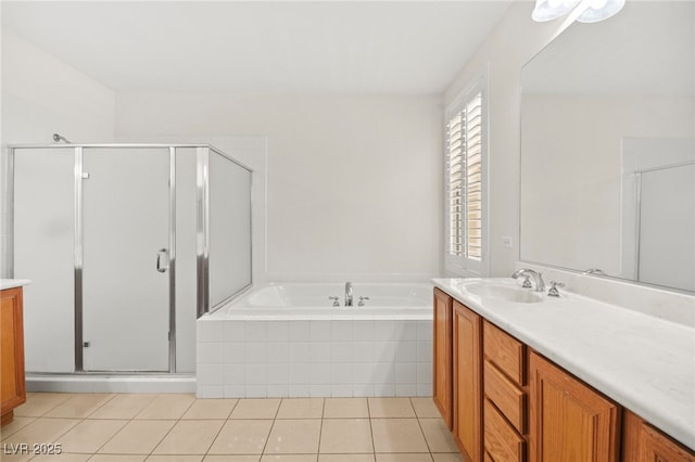 full bathroom featuring tile patterned flooring, a stall shower, vanity, and a garden tub