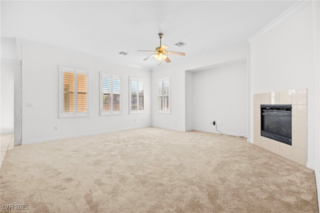 unfurnished living room with visible vents, carpet floors, ornamental molding, and a fireplace