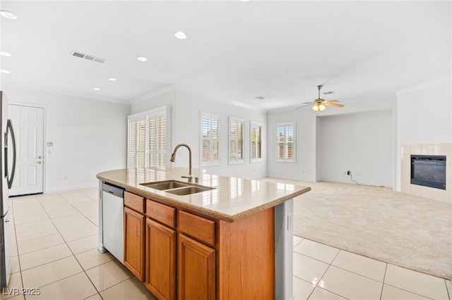 kitchen featuring visible vents, light carpet, ornamental molding, a sink, and dishwasher