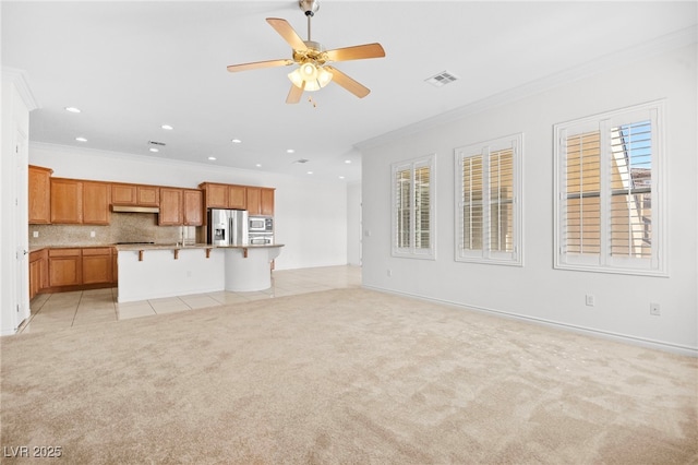 unfurnished living room featuring light tile patterned floors, visible vents, ceiling fan, light carpet, and crown molding