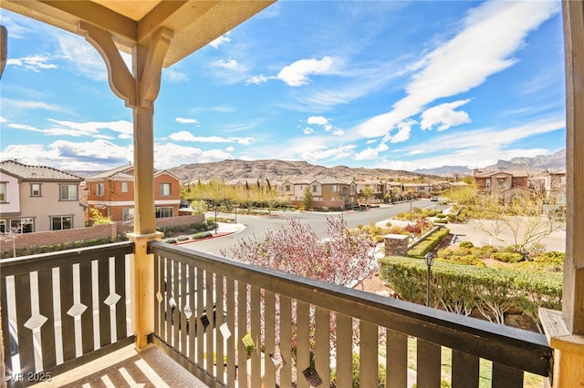 balcony featuring a mountain view and a residential view