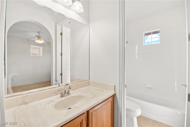 bathroom with toilet, a ceiling fan, vanity, tile patterned flooring, and shower / bathtub combination