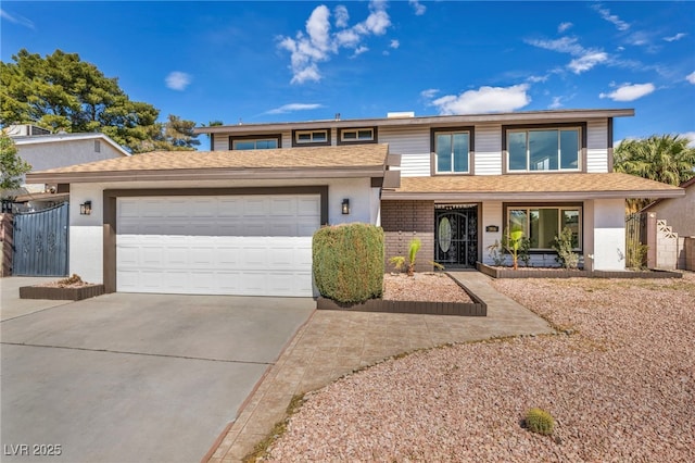 view of front of house featuring an attached garage, brick siding, driveway, and stucco siding