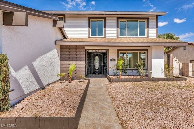 view of front of property with brick siding and stucco siding