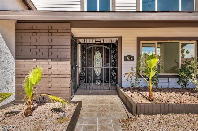 view of exterior entry with brick siding