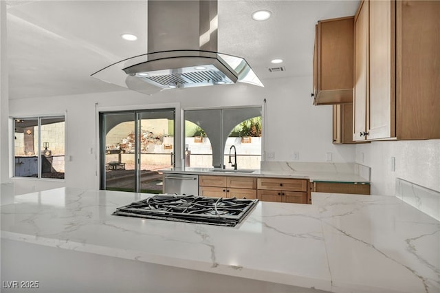 kitchen featuring light stone counters, a sink, black gas cooktop, dishwasher, and island range hood