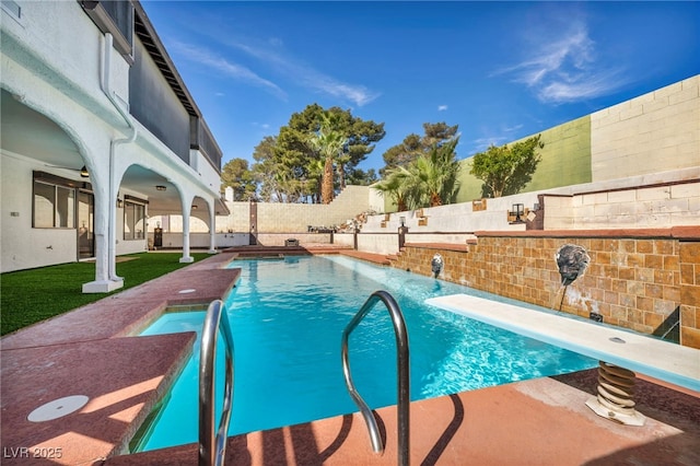 view of swimming pool with a patio area, a fenced in pool, a fenced backyard, and a diving board