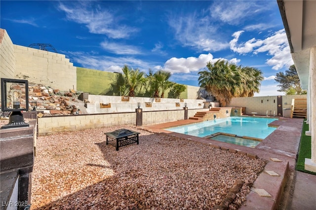 view of swimming pool featuring a fenced in pool, a fire pit, a fenced backyard, a patio area, and an in ground hot tub