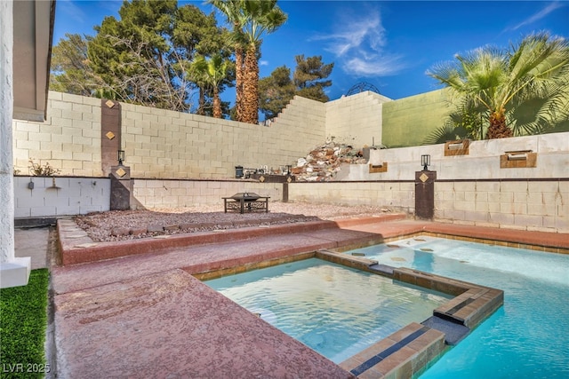 view of swimming pool featuring a pool with connected hot tub and a fenced backyard