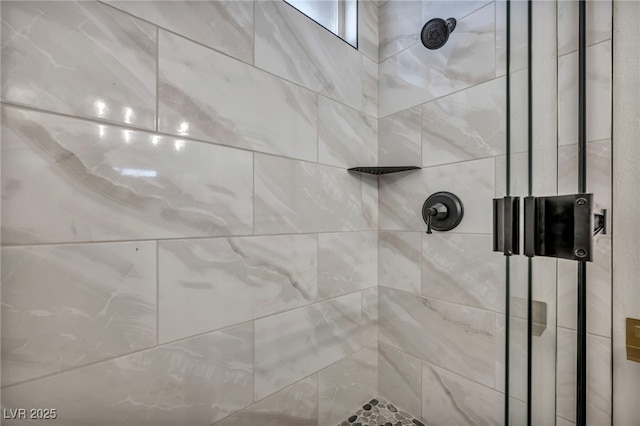 interior details featuring a tile shower