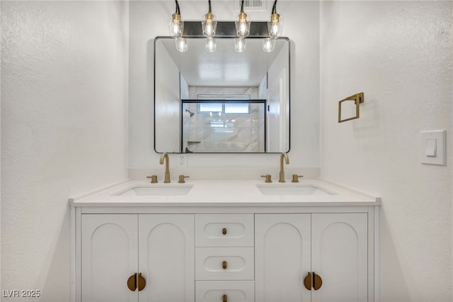 bathroom featuring a sink and double vanity