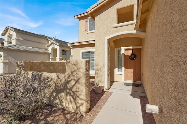 entrance to property with stucco siding