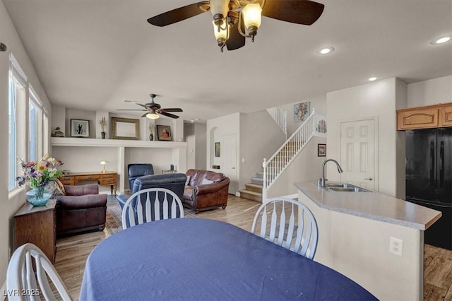 dining space with a ceiling fan, stairway, recessed lighting, and light wood finished floors