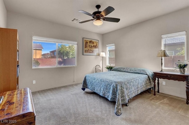 bedroom featuring baseboards, carpet, visible vents, and ceiling fan