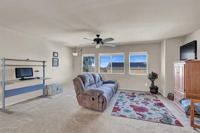 living room with a ceiling fan and carpet