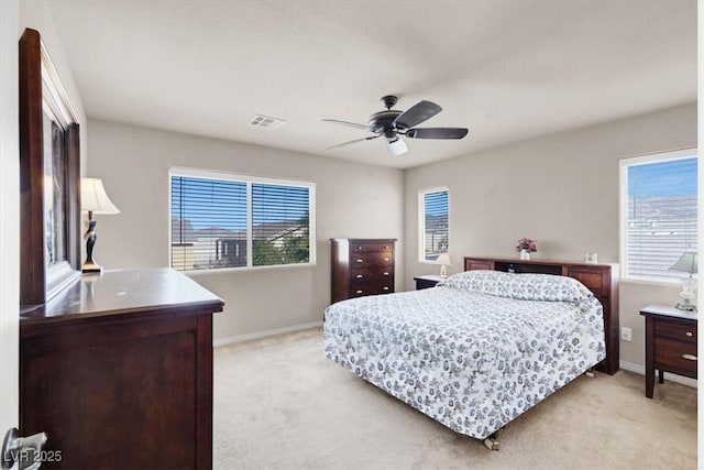 bedroom with light carpet, visible vents, and baseboards