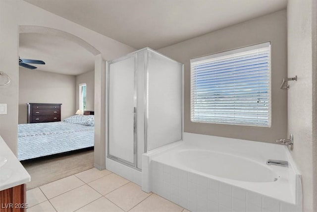 bathroom featuring tile patterned flooring, a garden tub, ensuite bathroom, vanity, and a ceiling fan