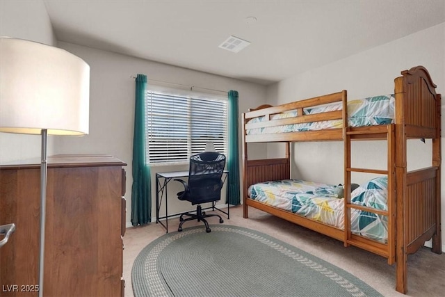 carpeted bedroom featuring visible vents