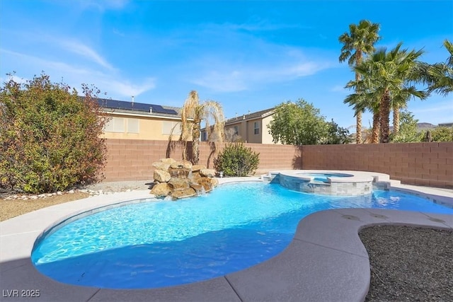 view of swimming pool with a fenced backyard and a pool with connected hot tub