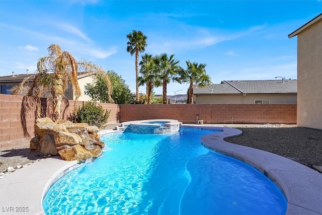 view of pool with a pool with connected hot tub and a fenced backyard