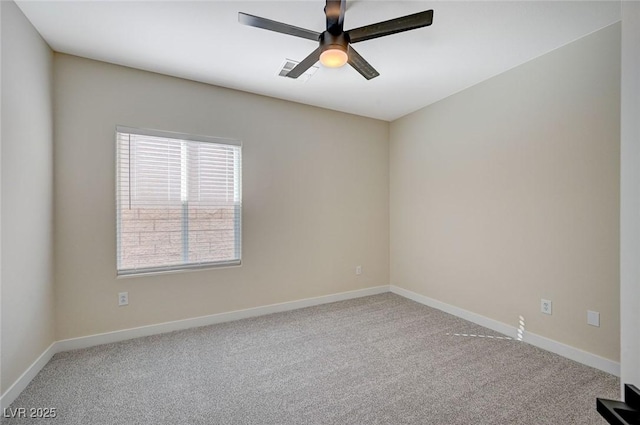 carpeted spare room featuring visible vents, baseboards, and a ceiling fan