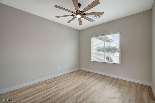 spare room featuring ceiling fan, baseboards, visible vents, and light wood-type flooring