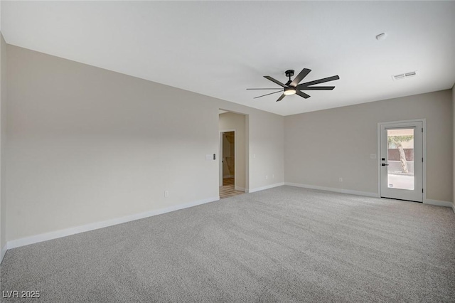 unfurnished room with light carpet, visible vents, ceiling fan, and baseboards