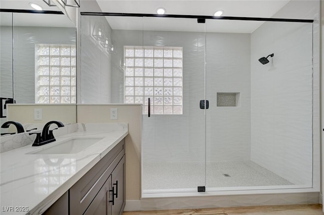 bathroom featuring vanity and a stall shower