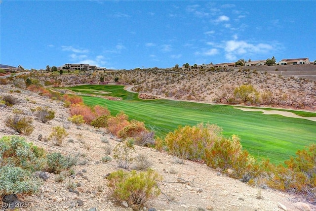 surrounding community featuring view of golf course and a lawn